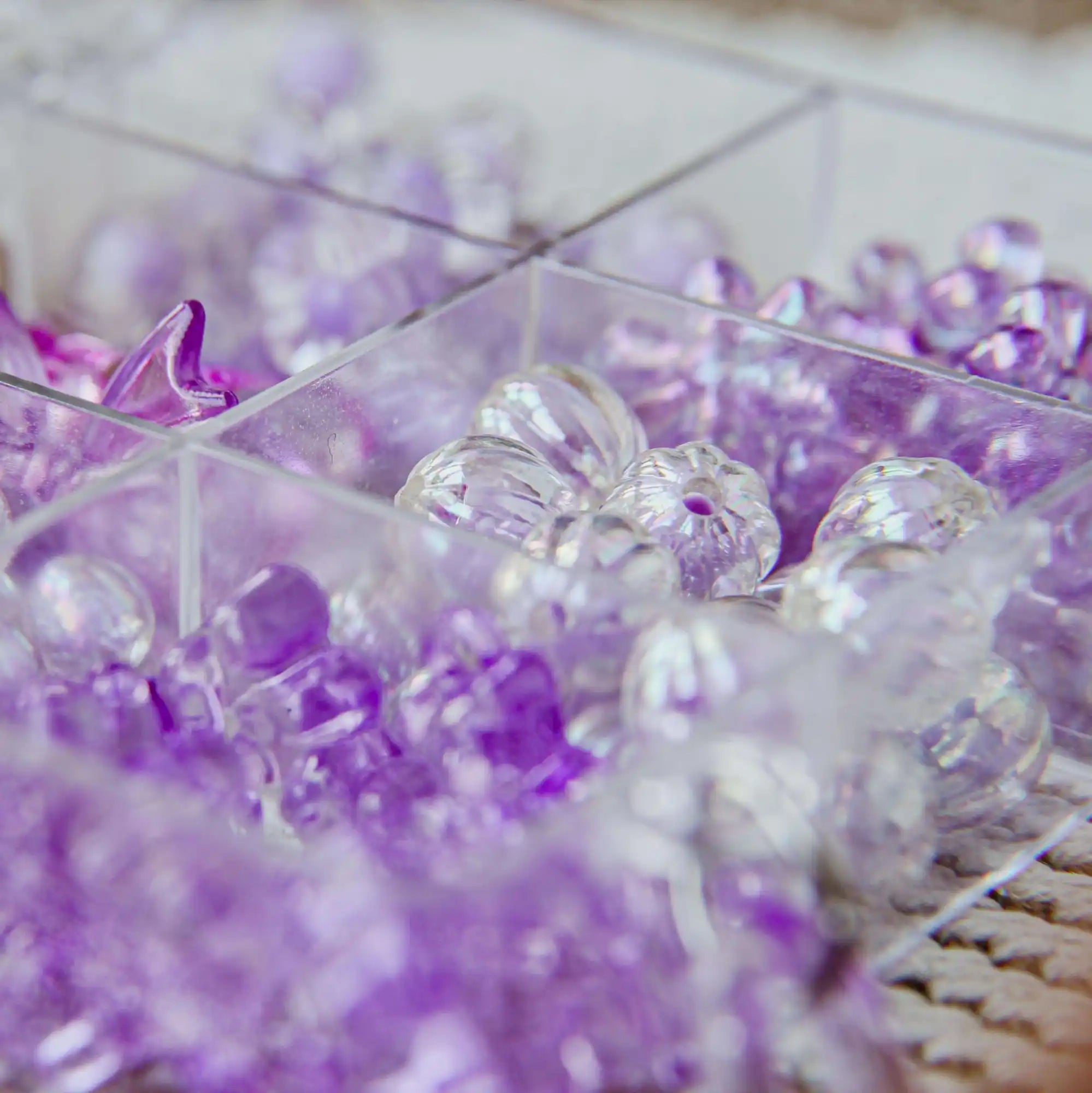 Purple and clear crystals or gemstones arranged together.